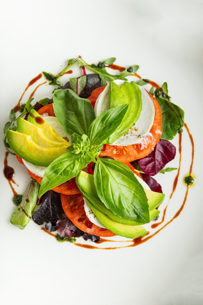 Salad of tomato, avocado and mozzarella with basil, from above