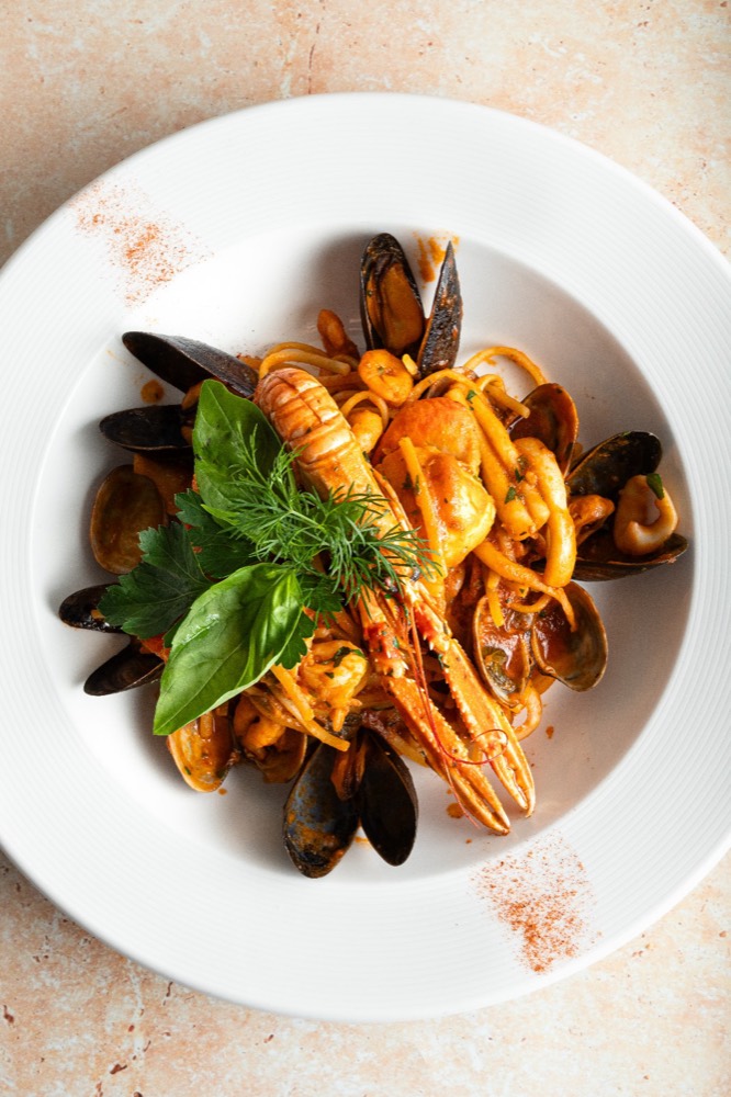 Seafood pasta from above with langoustine, mussels and basil